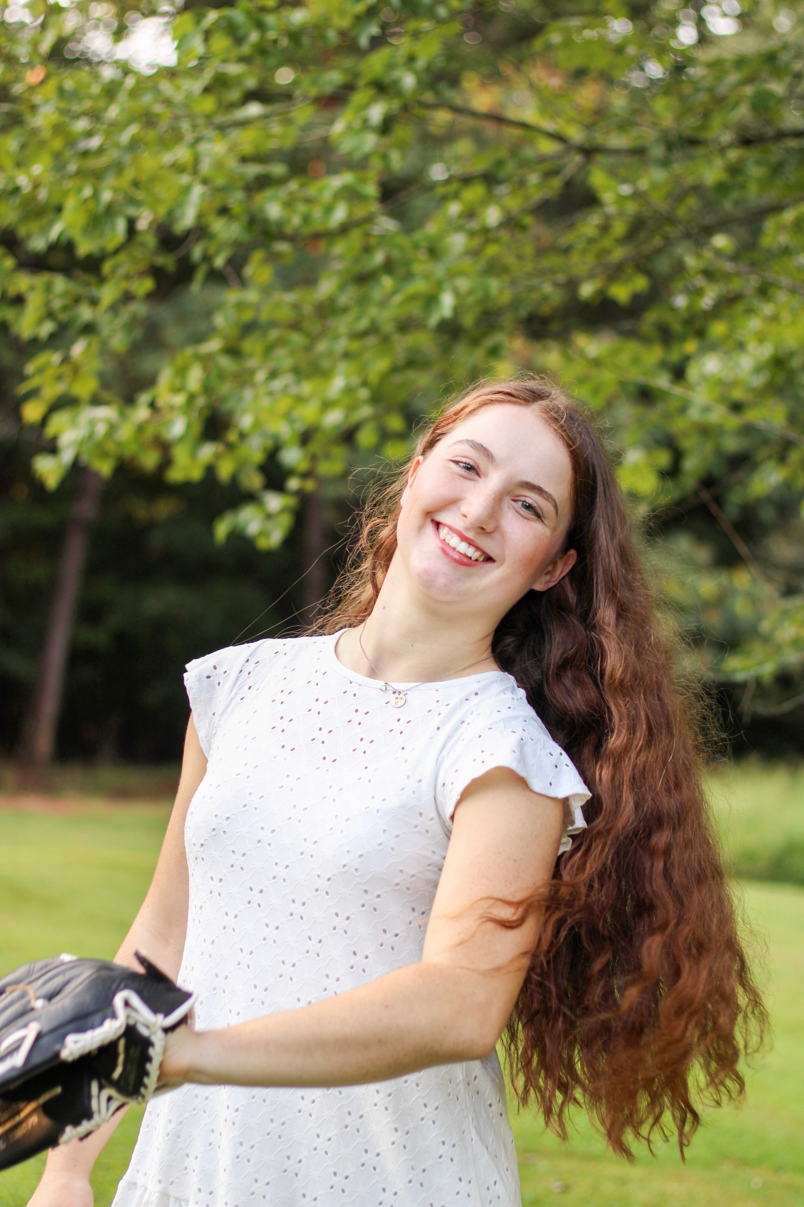 Smiling girl with long hair in outdoor portrait